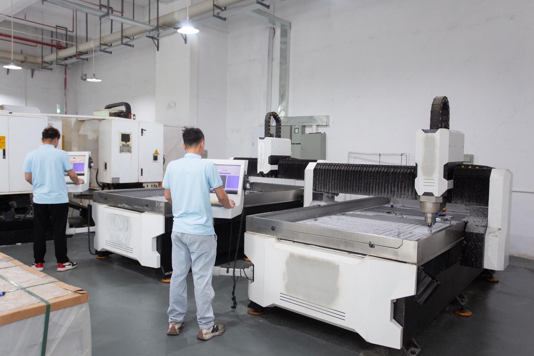 Real GX factory photo showing machining equipment and operators